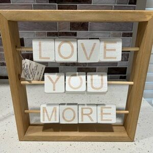 “Love You More” sign